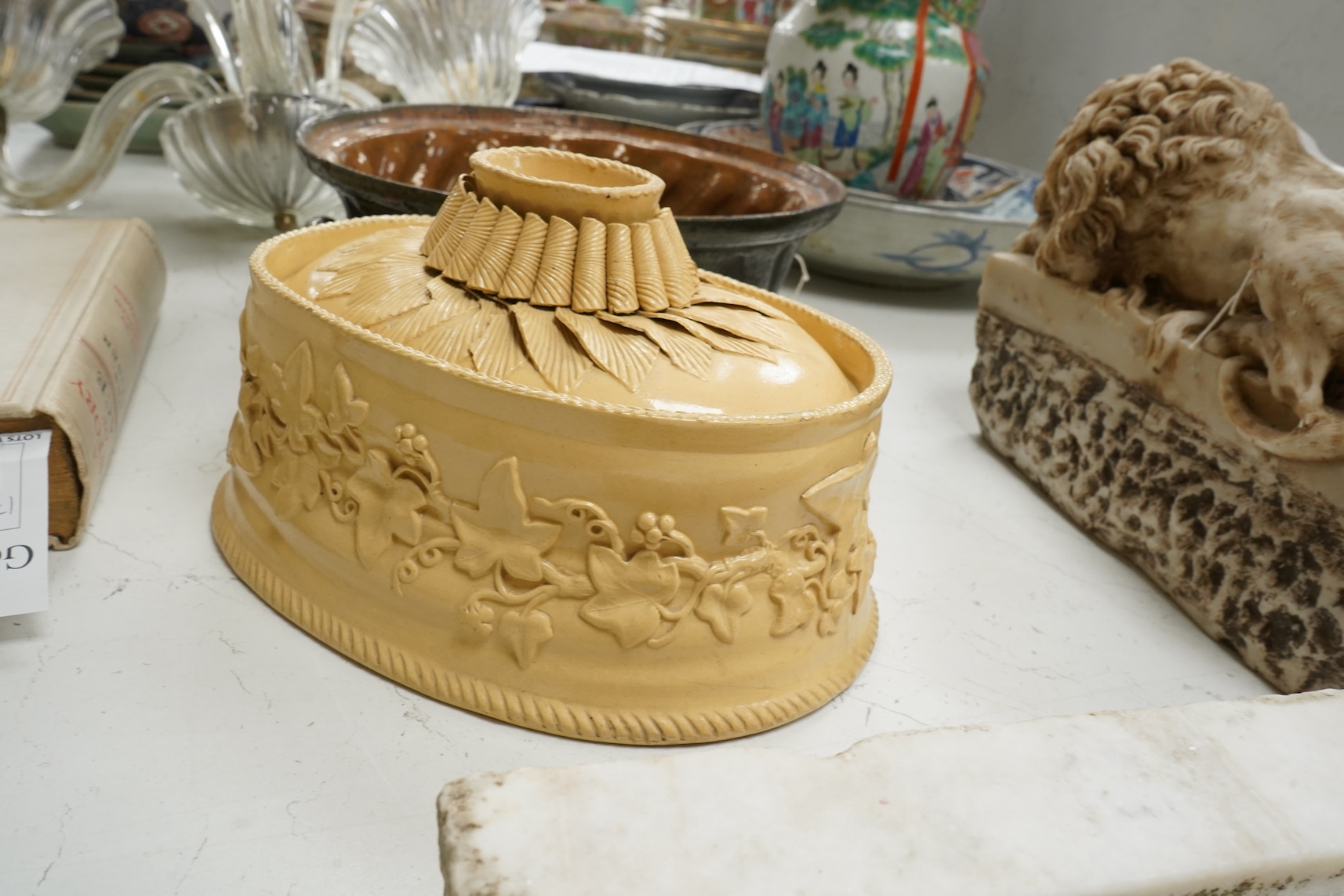 A 19th century oval caneware game/pie dish and cover, 24cm wide with an antique cake mould, (2)